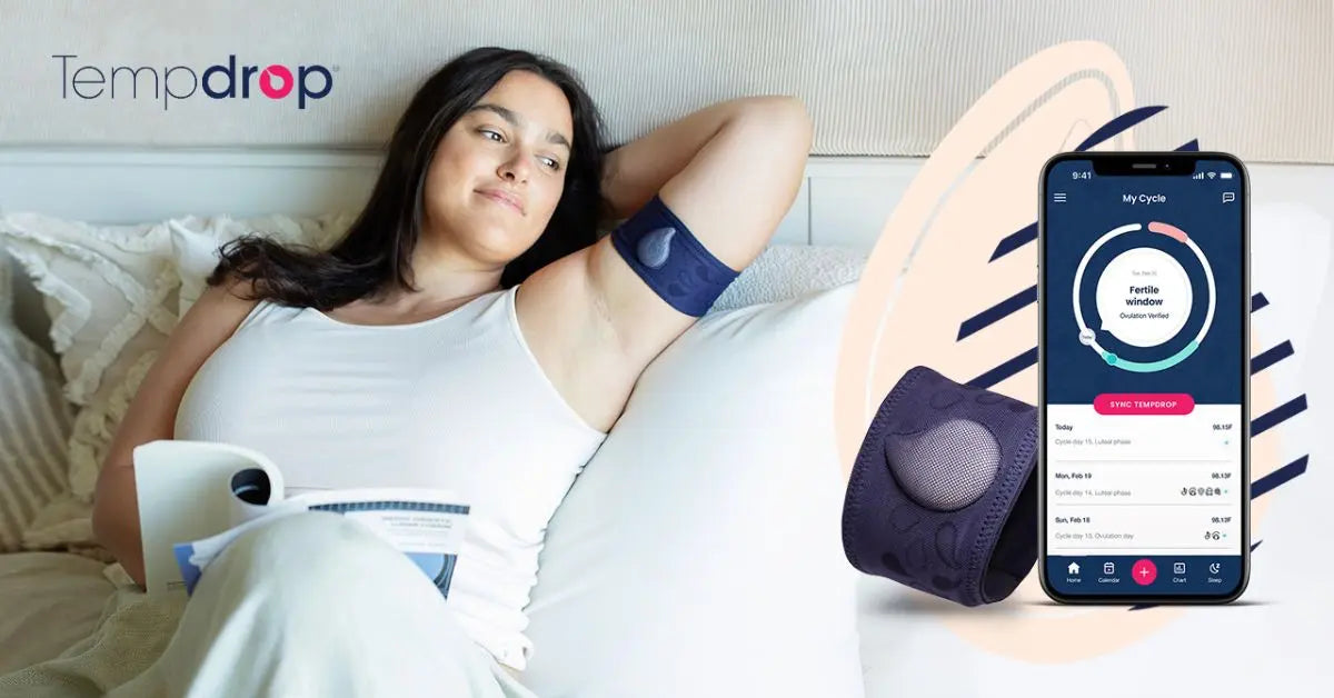 Woman reading fertility awareness guide with Tempdrop sensor and app
