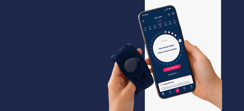 A woman holding the Tempdrop sensor and her phone with the Tempdrop app open. The app shows the latest app updates released.